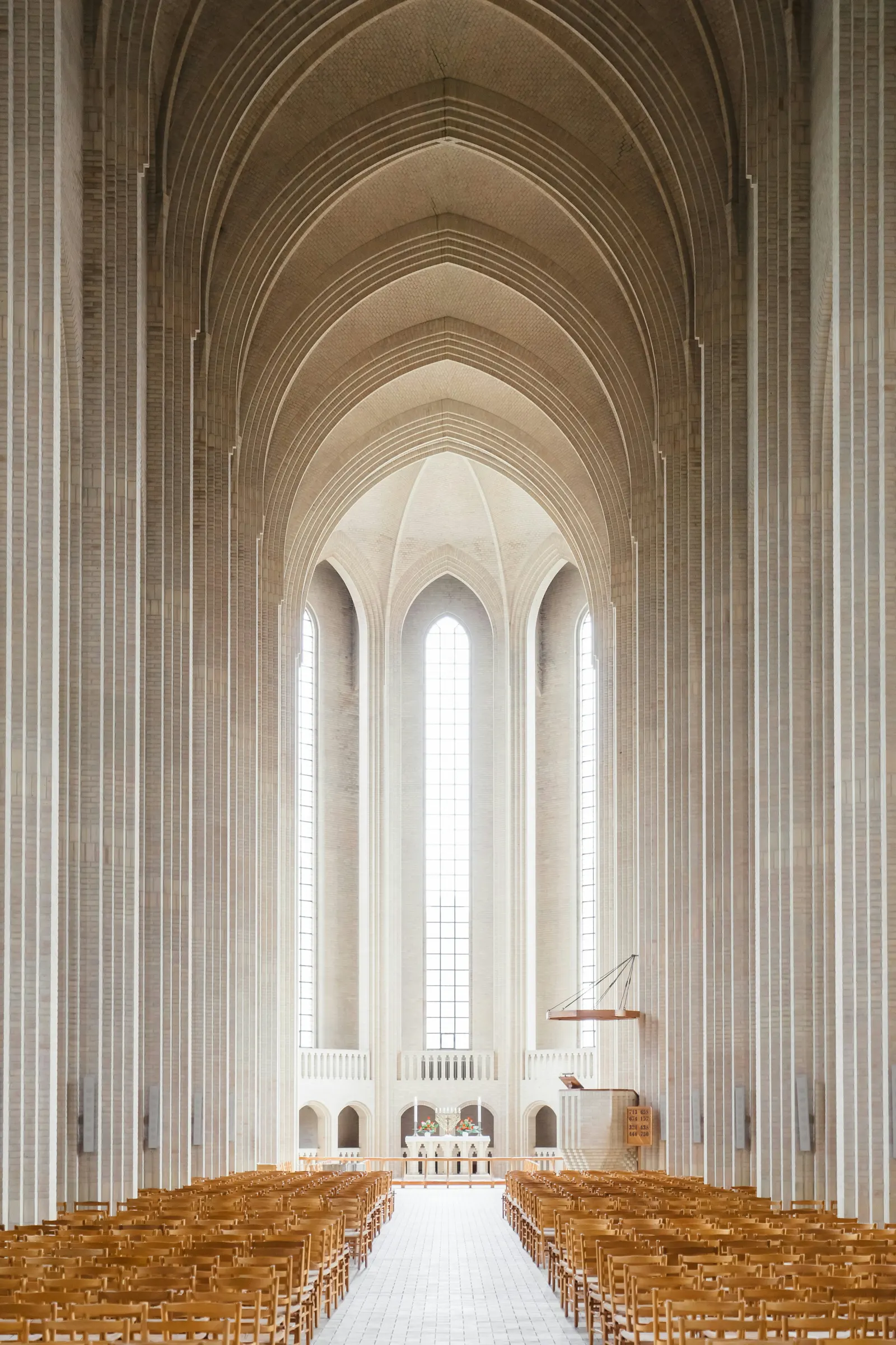 A light-filled church nave with tall arched windows