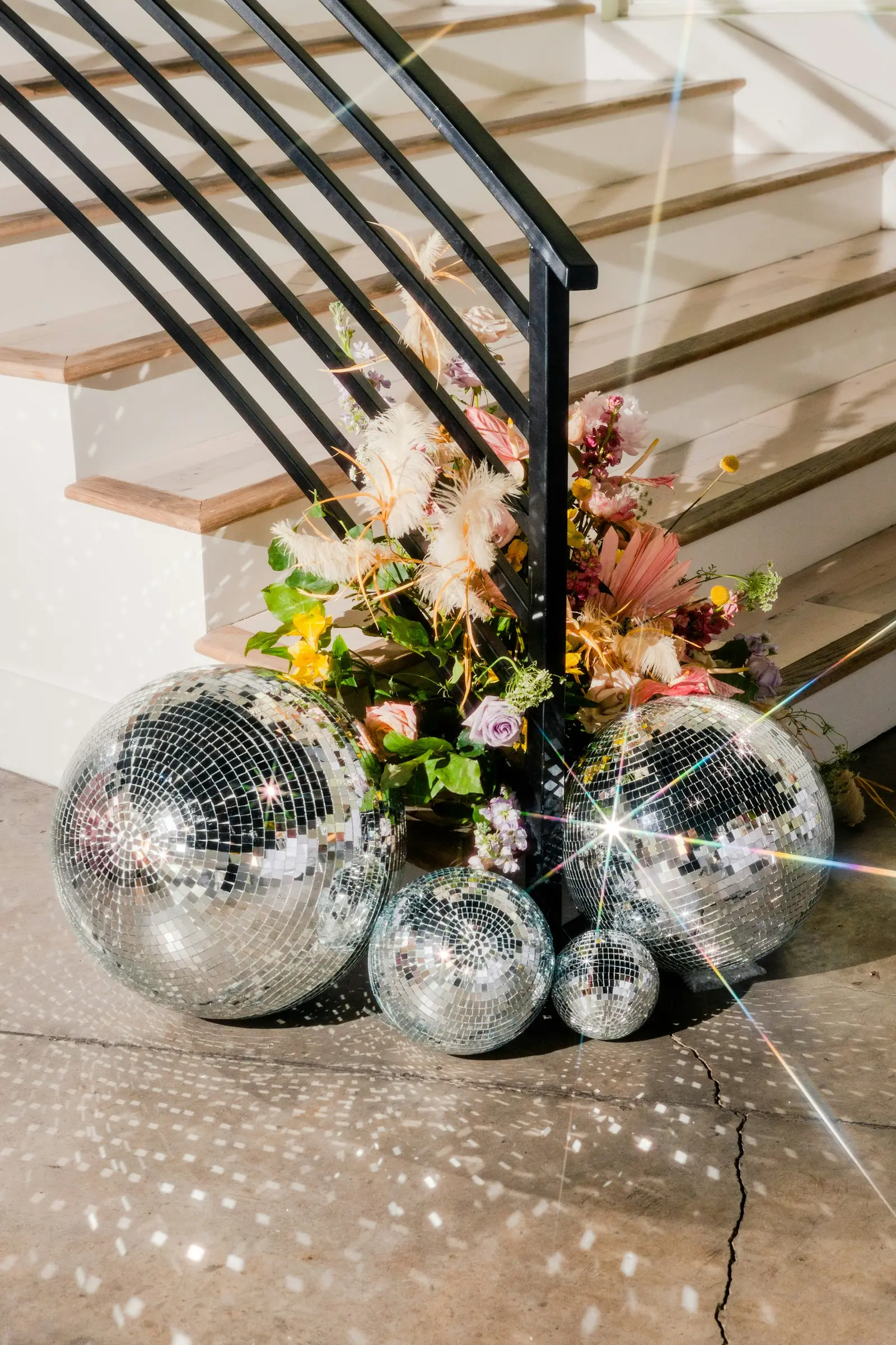 The villa staircase with disco balls and flowers